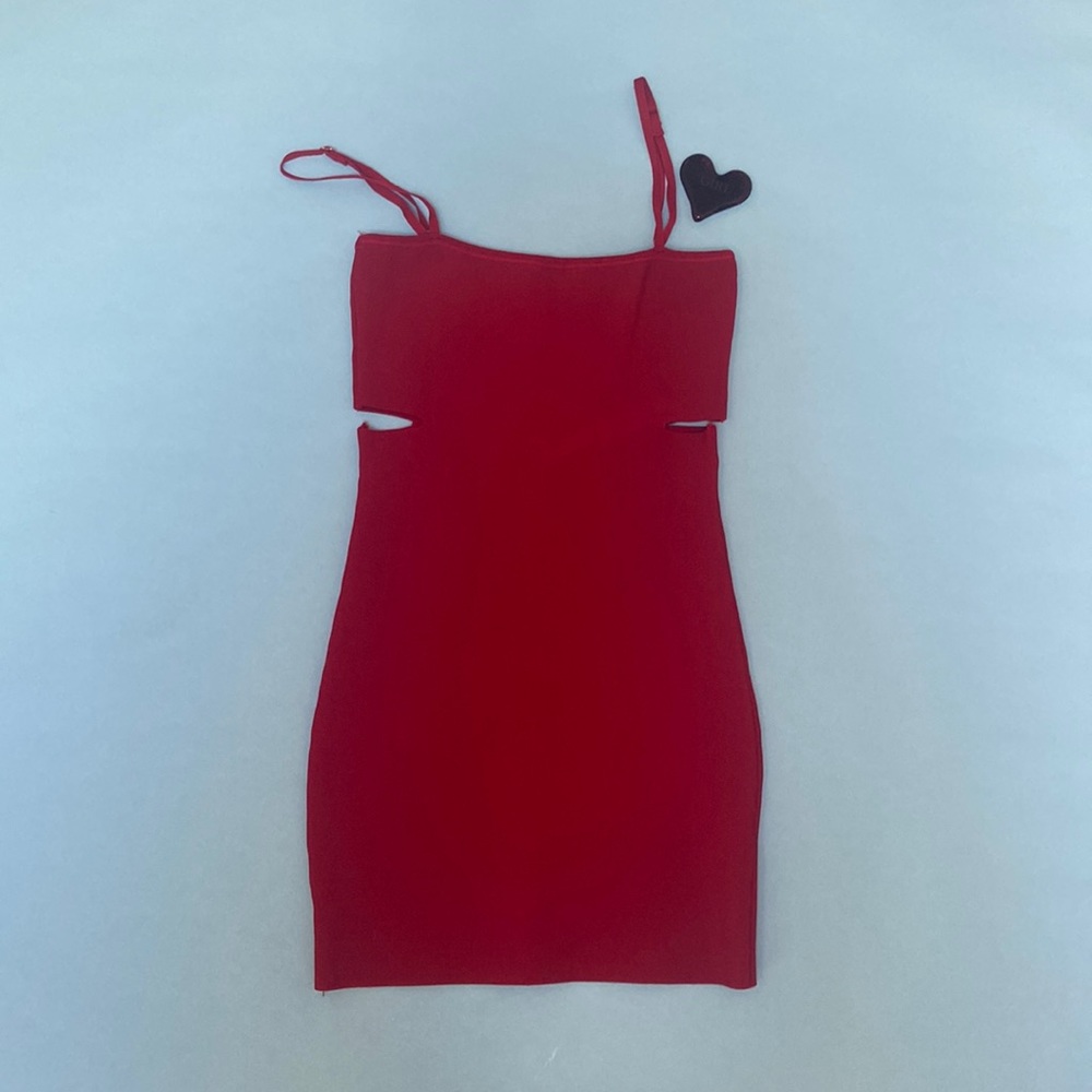 Red cocktail dress. Spaghetti straps and design cutout to show skin.